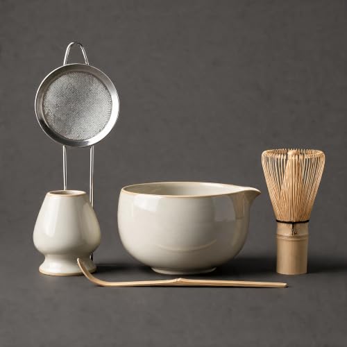 Mawakin Matcha Ritual Kit in off-white: ceramic bowl with pouring spout, bamboo whisk, stainless steel sifter, bamboo scoop and ceramic whisk holder.